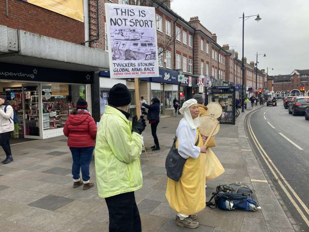 Campaigners held up posters condemning the armoured vehicles fair