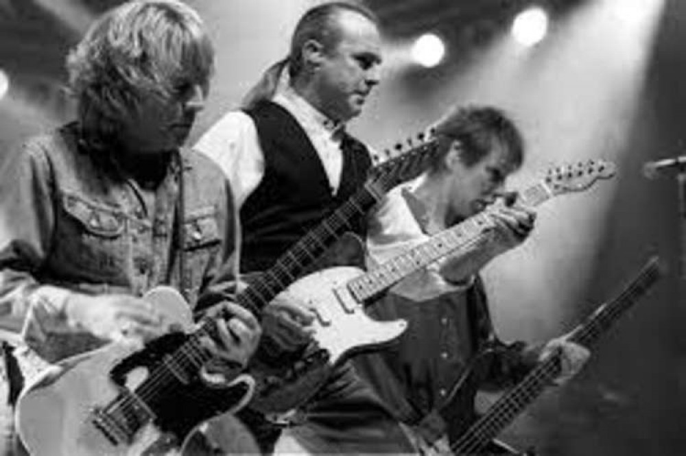 John performing with Status Quo. Pictured: Francis Rossi and Rick Parfitt, who died aged 68 in 2016 John performing with Status Quo. Pictured: Francis Rossi and Rick Parfitt, who died aged 68 in 2016