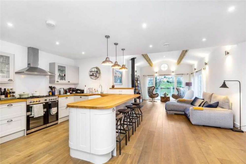 The open-plan kitchen and living room looks out onto the river (Image: Savills)