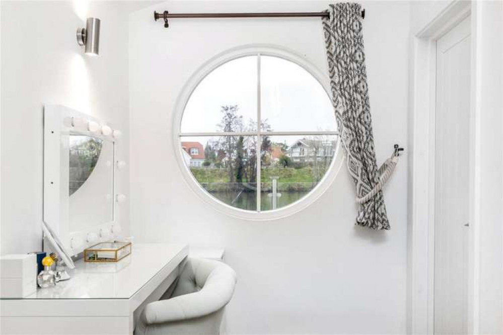 Nautical style round windows enhance the riverside feel (Image: Savills)