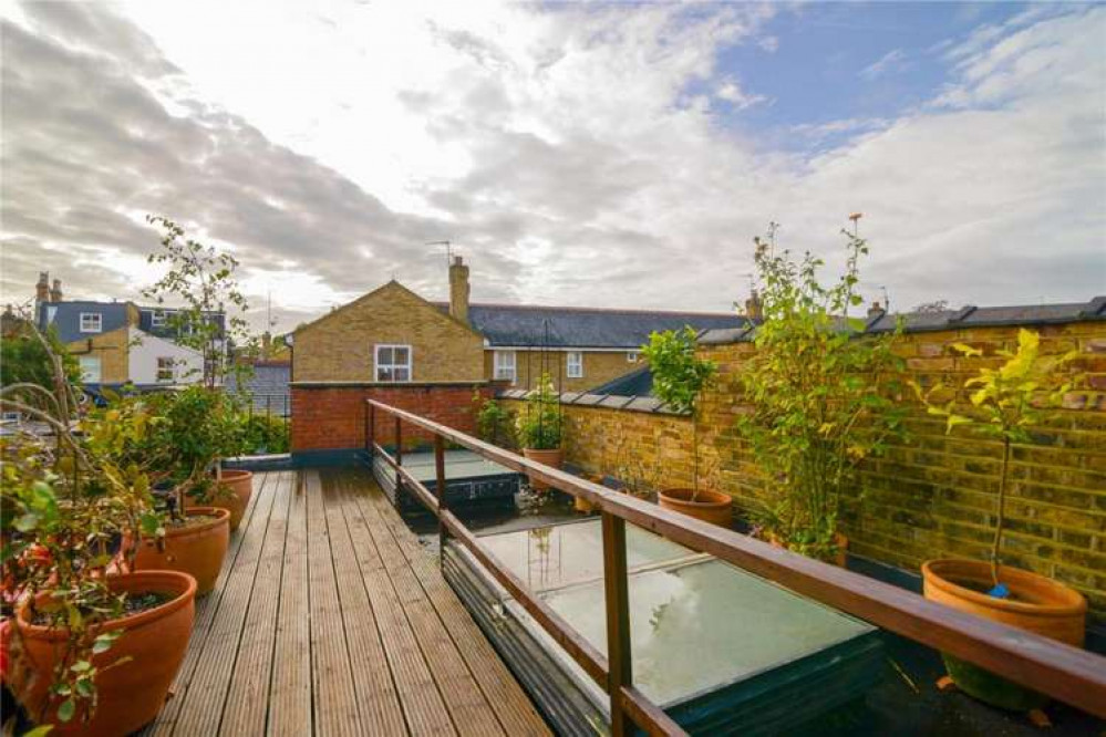 Residents can enjoy a shared outdoor space with plant pots and picnic benches