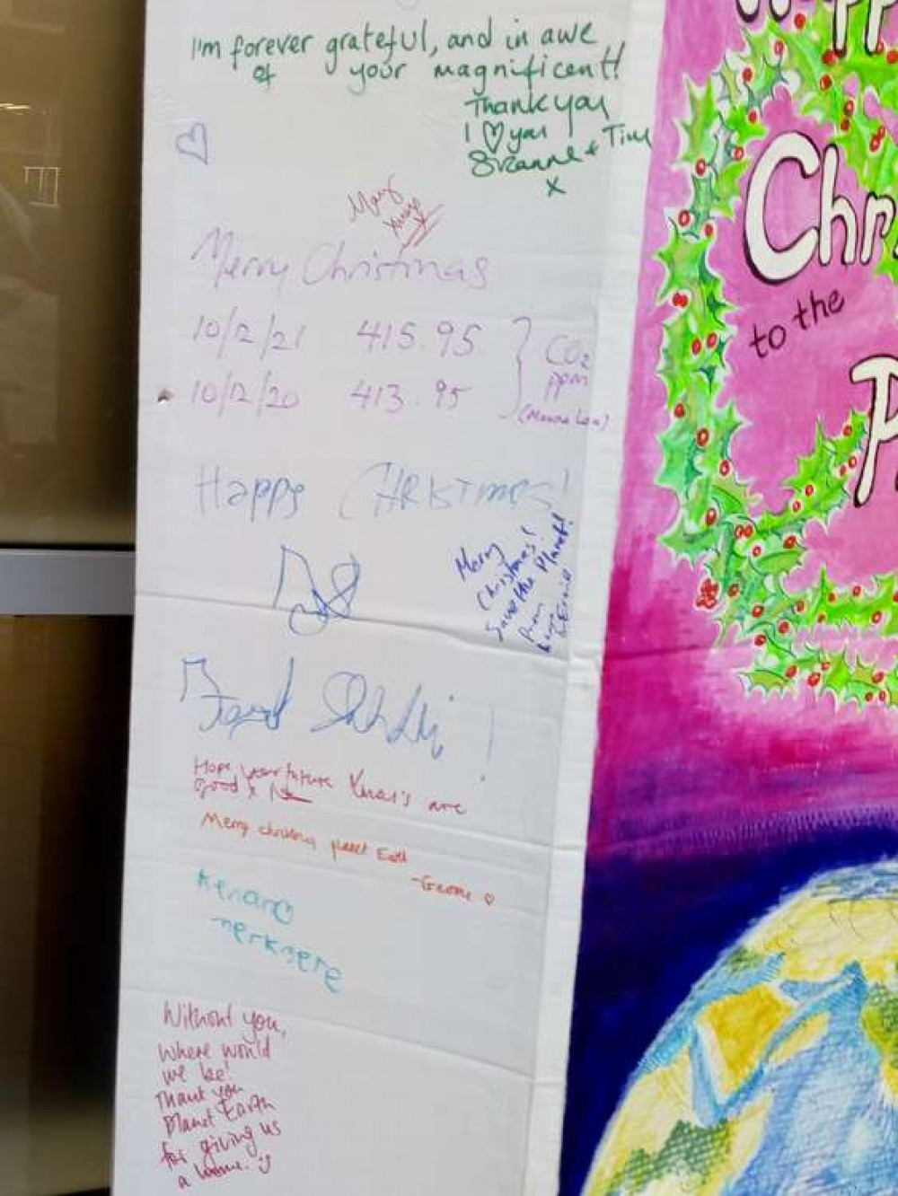 Passersby wrote messages on a giant Xmas card to the planet