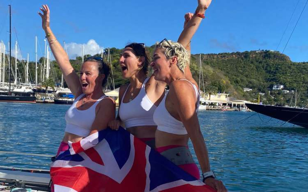 L to R: Abby Johnston, Charlotte Irving and Kat Cordiner cheer with the UK flag on their arrival to Antigua L to R: Abby Johnston, Charlotte Irving and Kat Cordiner cheer with the UK flag on their arrival to Antigua