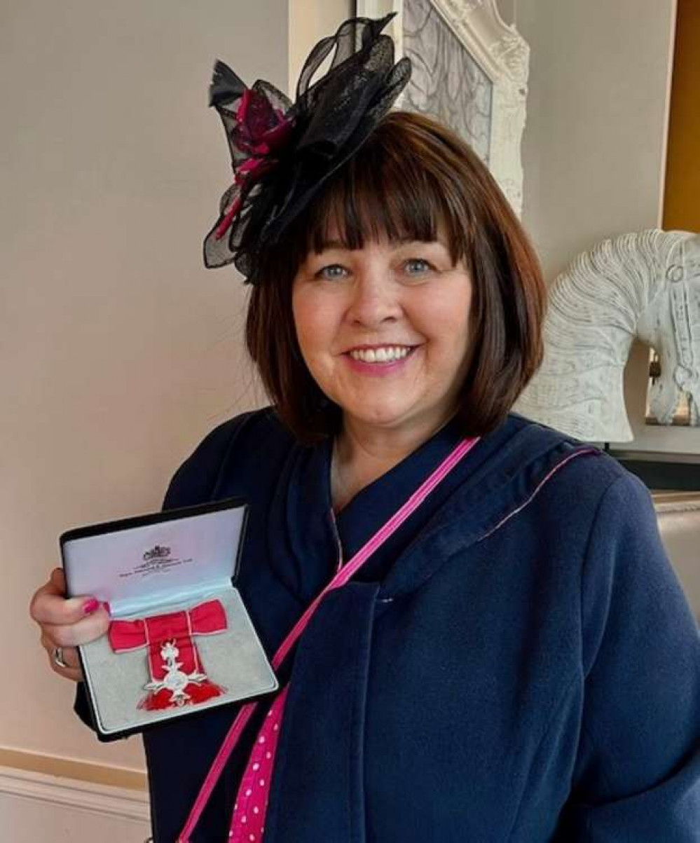 Karen Deverell with her MBE at Windsor Castle Karen Deverell with her MBE at Windsor Castle