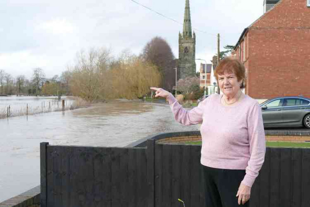 Watering the garden: Pat Freer points to the burst River Anker literally on her doorstep