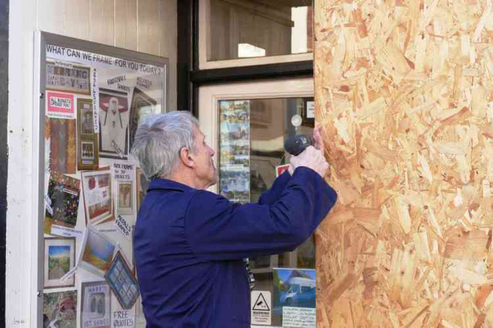 Last minute adjustment: There's an art to this boarding up, at Atherstone Gallery