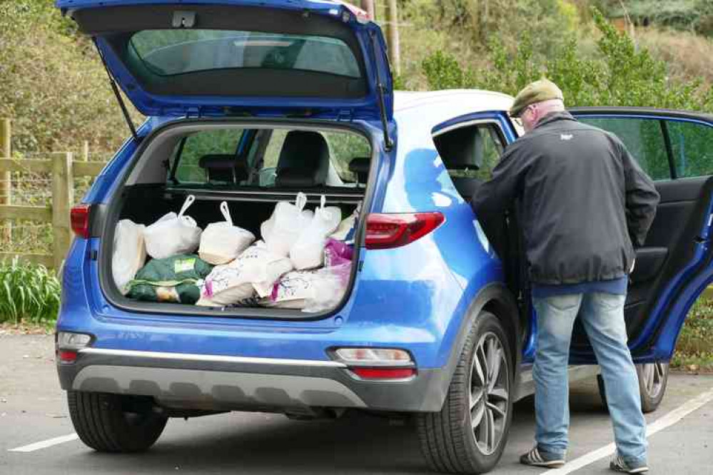 Boot-i-ful: Baddesley Social Club chairman Rob Jakes puts more meals on the back seat of his car