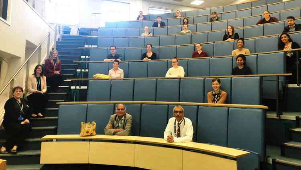 United apart: Medical students listen intently as they keep their distance