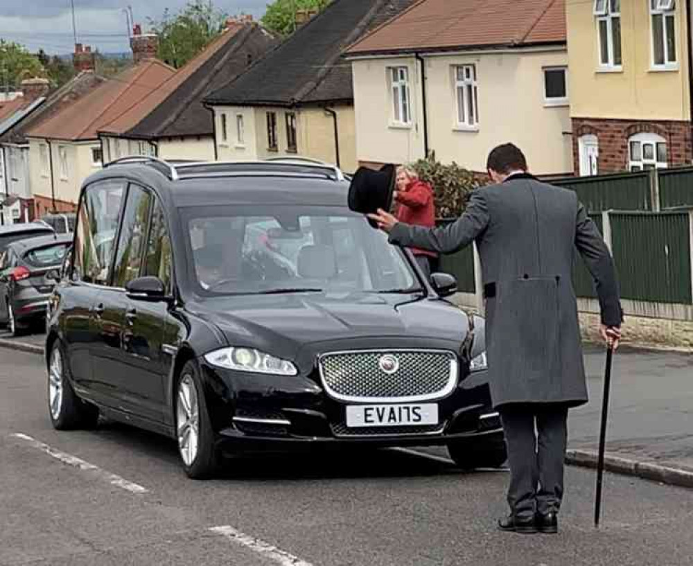 Head bowed: The funeral director pays his respects