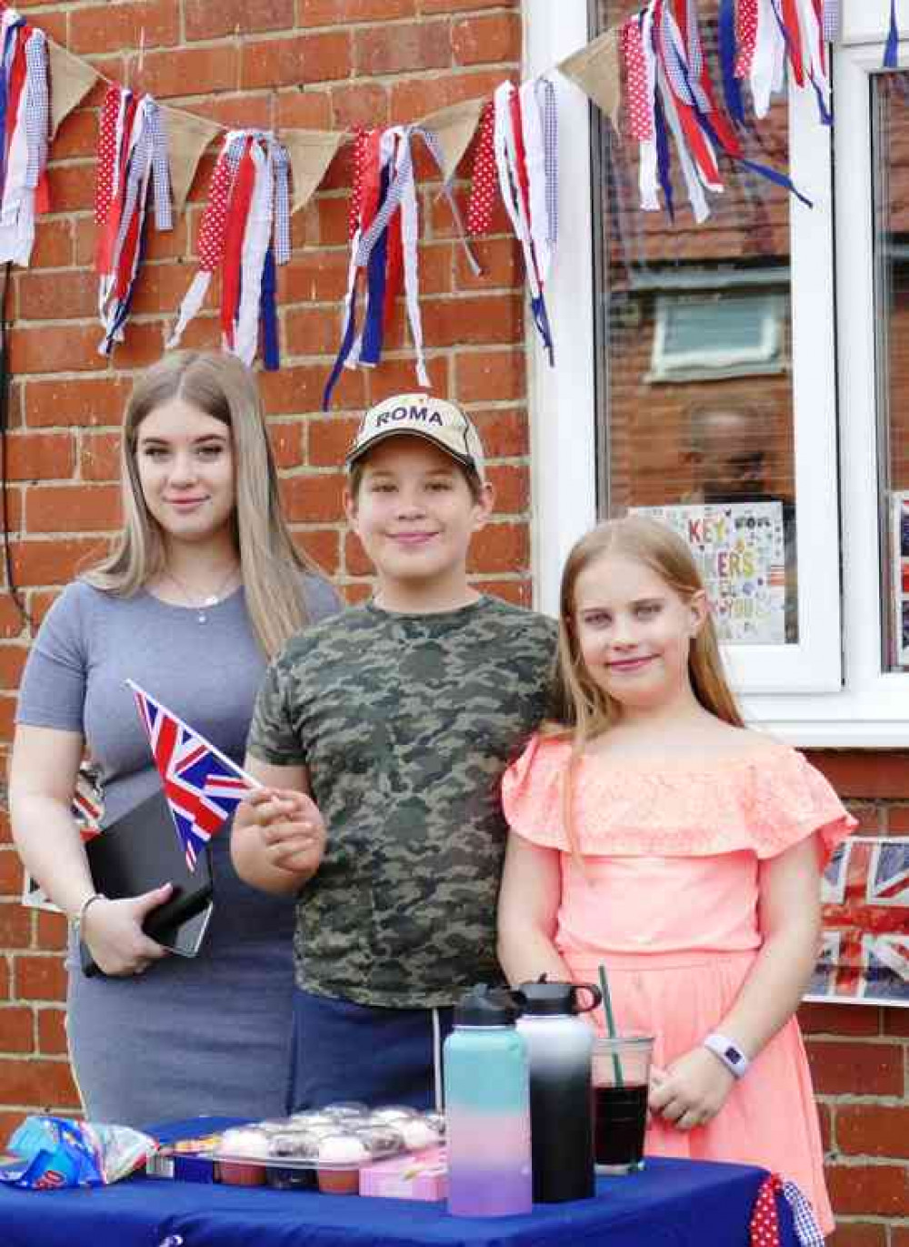 Three's an 'in' crowd; This family trio wait for their VE75 afternoon tea