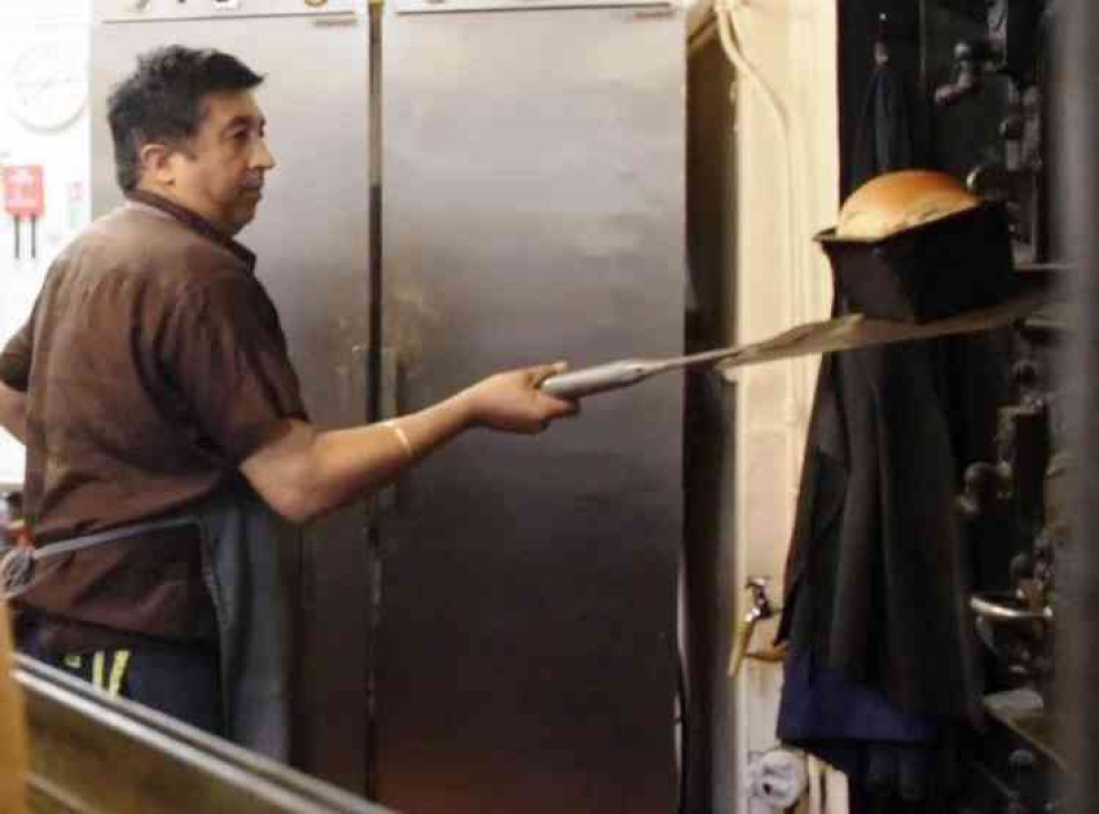 Masters baker: Mejar Singh takes a loaf from the oven at his shop