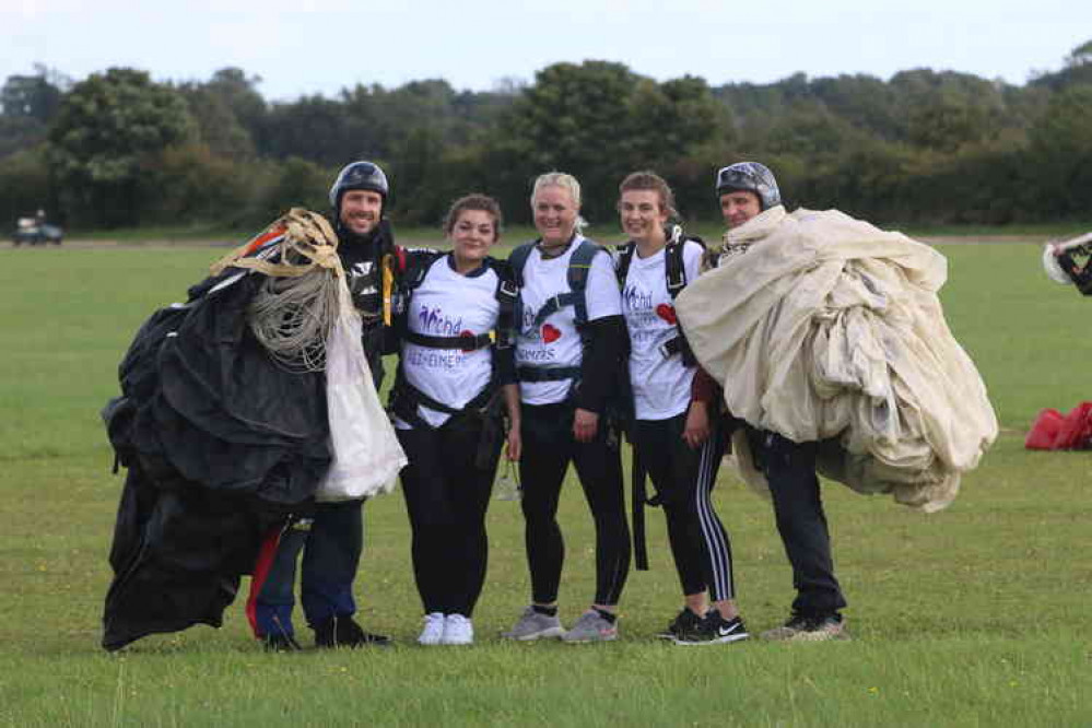 Emma Packer, Emma Leahy and Emily Reynolds with instructors after their skydive.