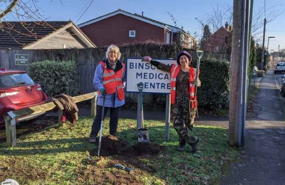 Town councillors Heather Hullah and Shirley Wardell planting bulbs outside Binscombe Surgery.