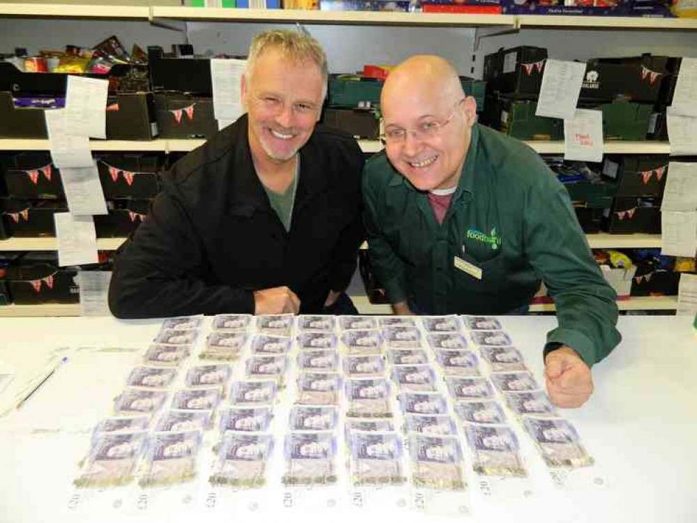 Coun Dean Ward ready to bank £1,000 with Grantham Foodbank coordinator Brian Hanbury