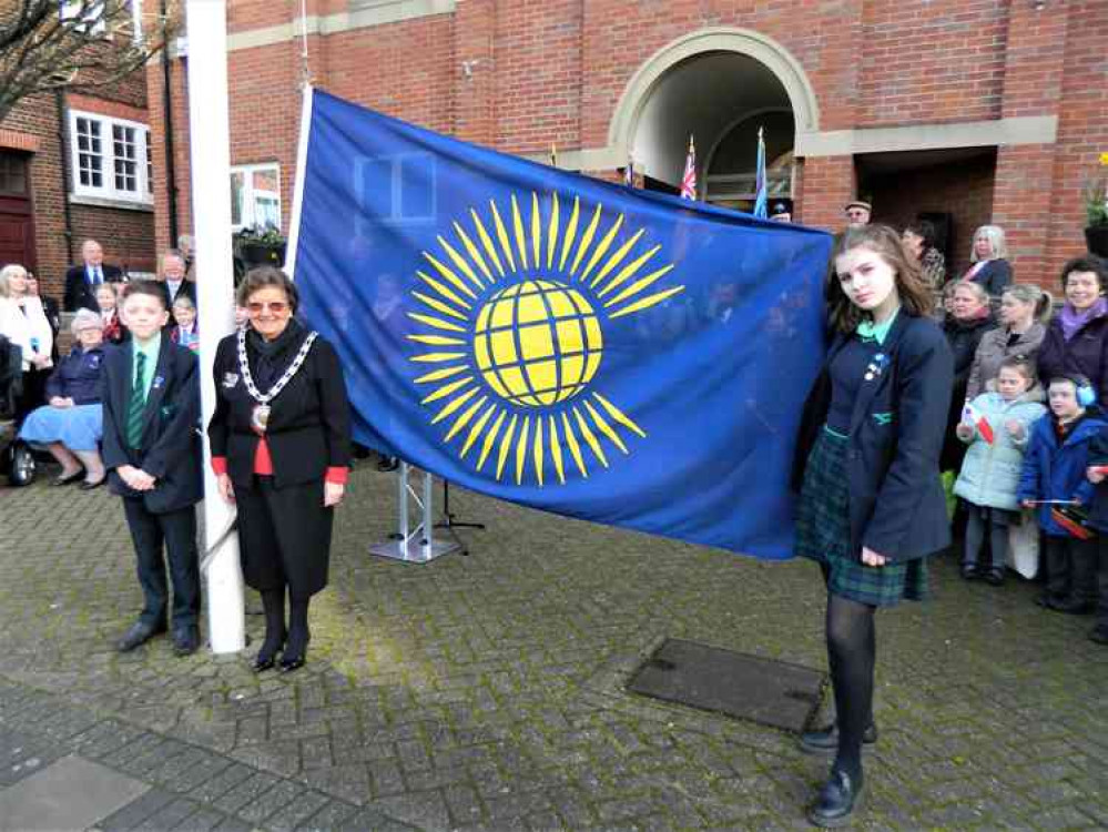 Youngsters from Walton Academy assist with the Commonwealth Day flag raising.