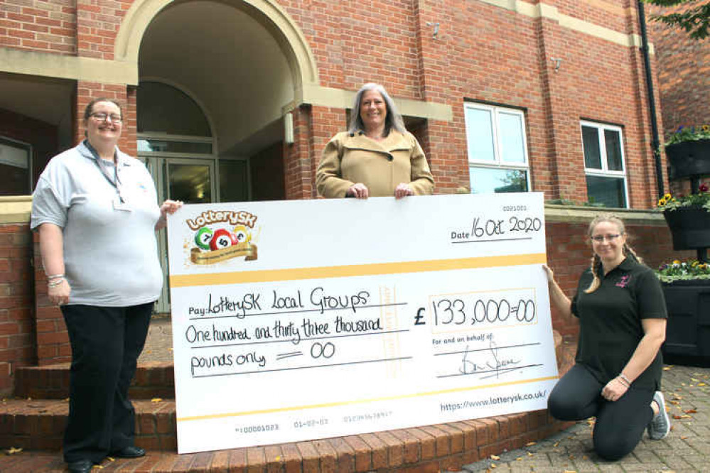 A big payout for LotterySK good causes; Cllr Annie Mason (centre) with sisters Katie Bennington of top beneficiary FOSA (right) and Lucy Moore, fund raiser for Dancepointe