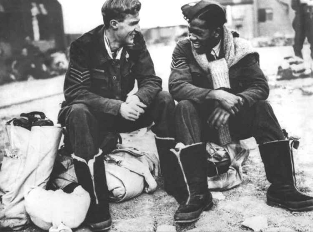 Illustrating the comradeship in WWll, Sgt Leslie Gilkes from Trinidad, air gunner with No. 9 Squadron Bomber Command, with fellow air gunner Sgt J C Dickinson Royal Canadian Air Force.