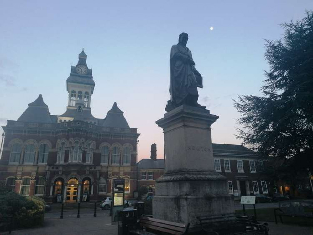 The statue of Sir Isaac Newton as night falls