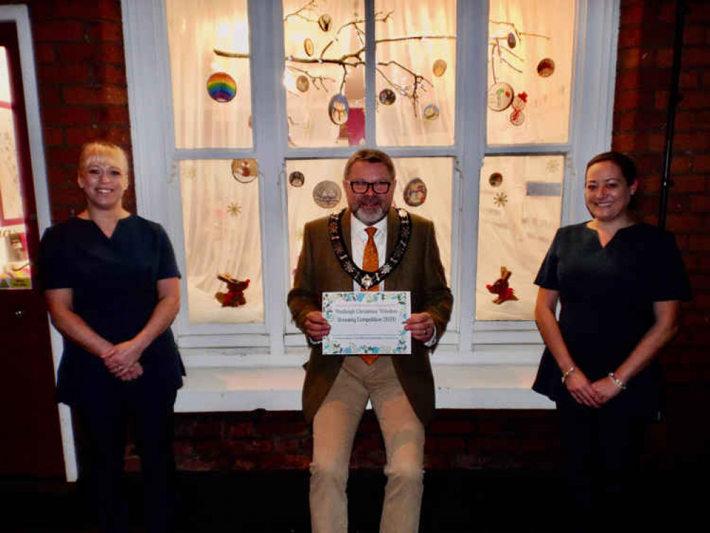 Terrie Redmore and Ellen Hufford with Mayor Frank Minns and A Touch of Beauty's winning window