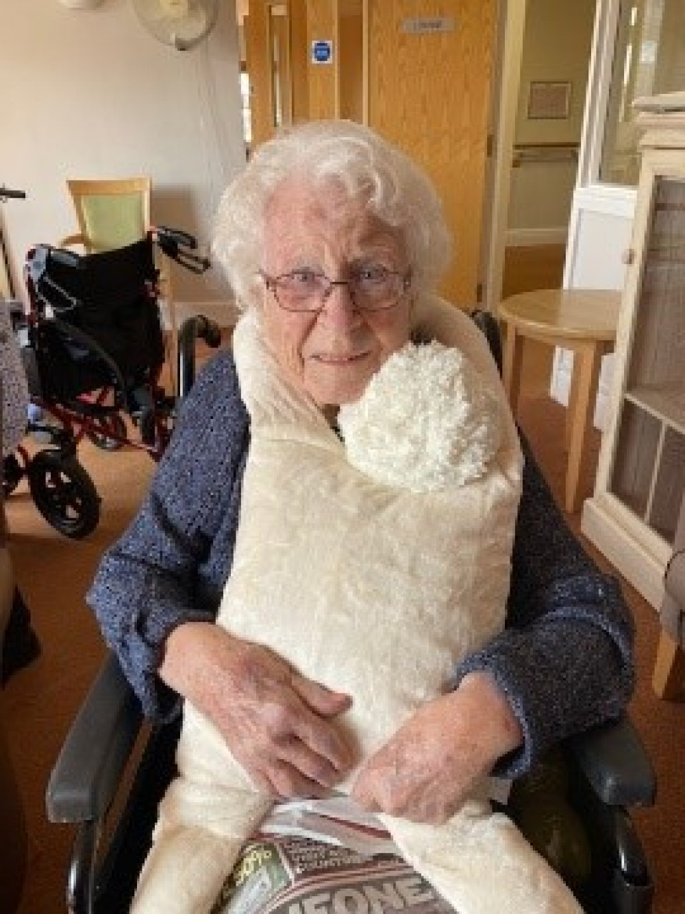 June Janes giving the doll a big cuddle. (Image credit: Methodist Homes - MHA)