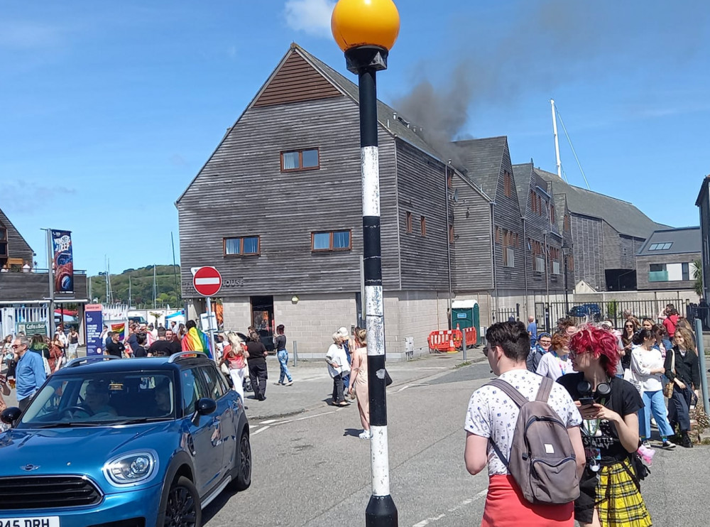 Falmouth Pride watches on as smoke started billowing out of Tidemill House. Photo taken by Kelly Davis.