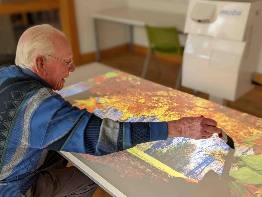 Photo of man using OMI Interactive Projector Photo of man using OMI Interactive Projector