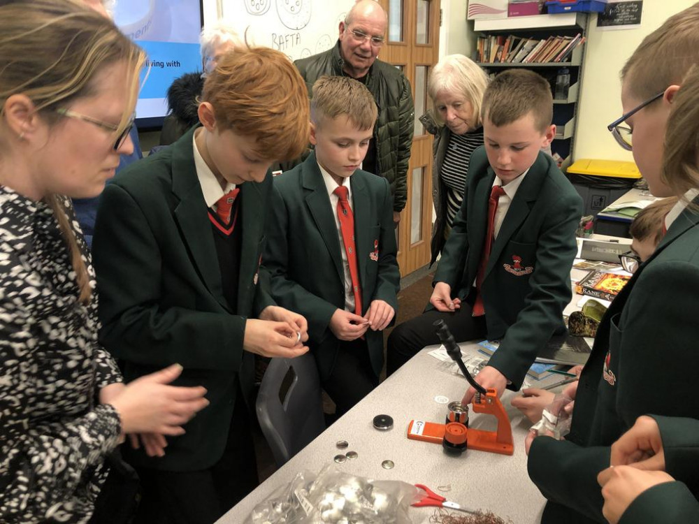 Teacher Tracy Shone oversees badge production. Looking on in the background DFS steering group members Neil Mckellar (centre) and Wendy  Whitworth.