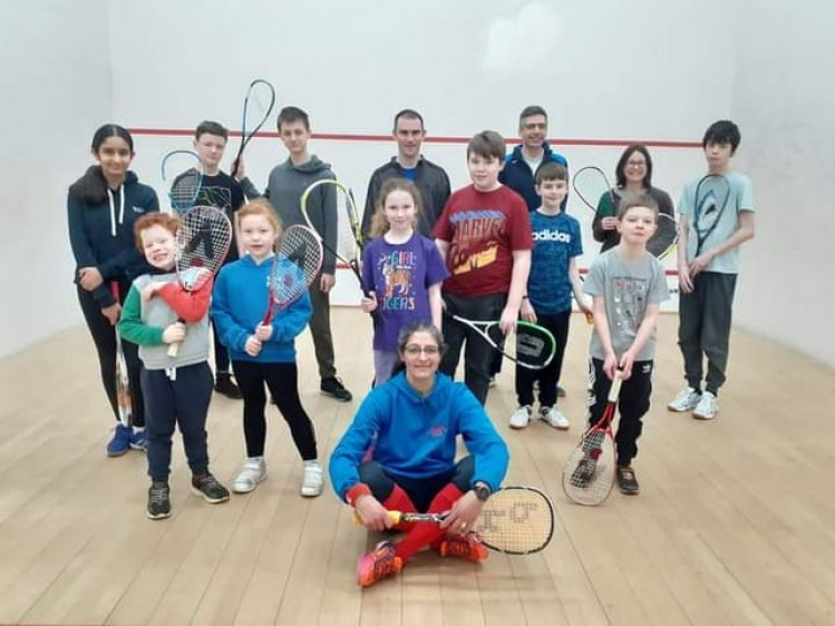 Coach Alison Insley on court with some of her junior squash players