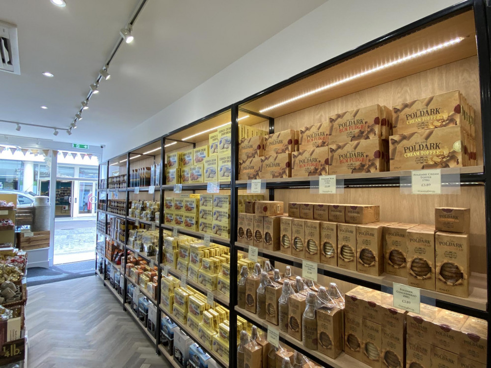 A variety of biscuits, fudge, and drinks. 