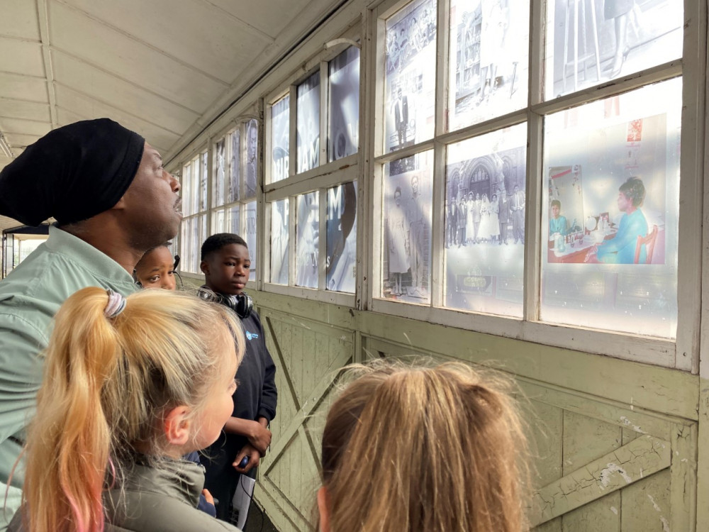 Children with artist Everton Wright who created the Walkway of Memories at Tilbury.