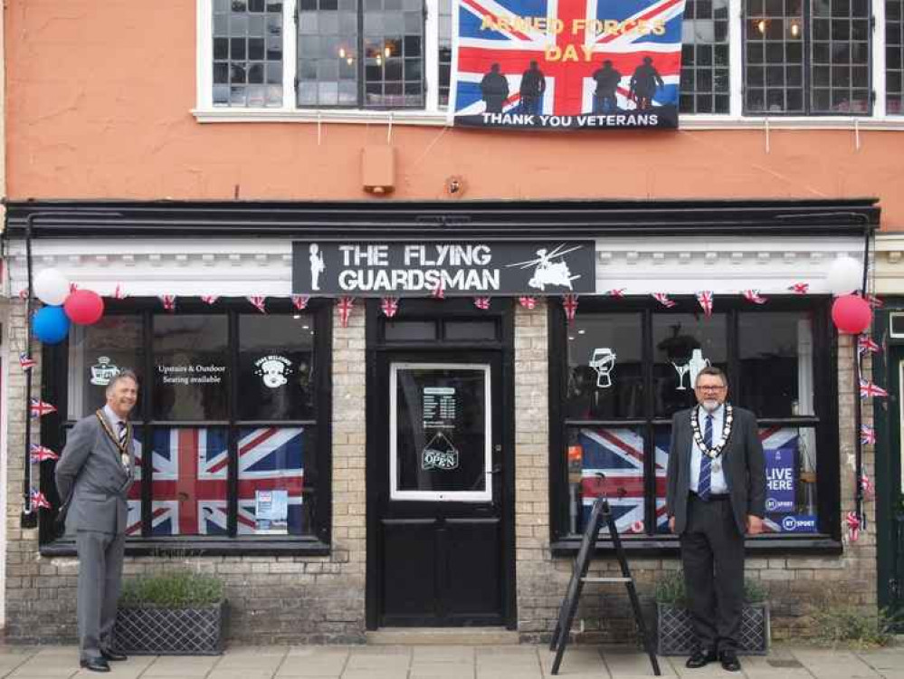 Babergh District Council's Chairman Cllr Adrian Osborne (left) and Mayor of Hadleigh Cllr Frank Minns (right) outside The Flying Guardsman, one of the town's businesses participating in the town's Armed Forces Day Window Trail. Picture and credit: