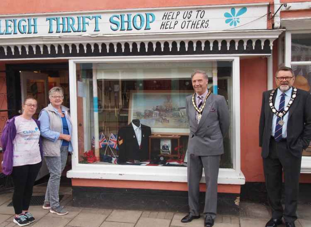 May Minns with Babergh chairman Adrian Osborne and a couple of The Thrift Shop staff with an army jacket in the window display