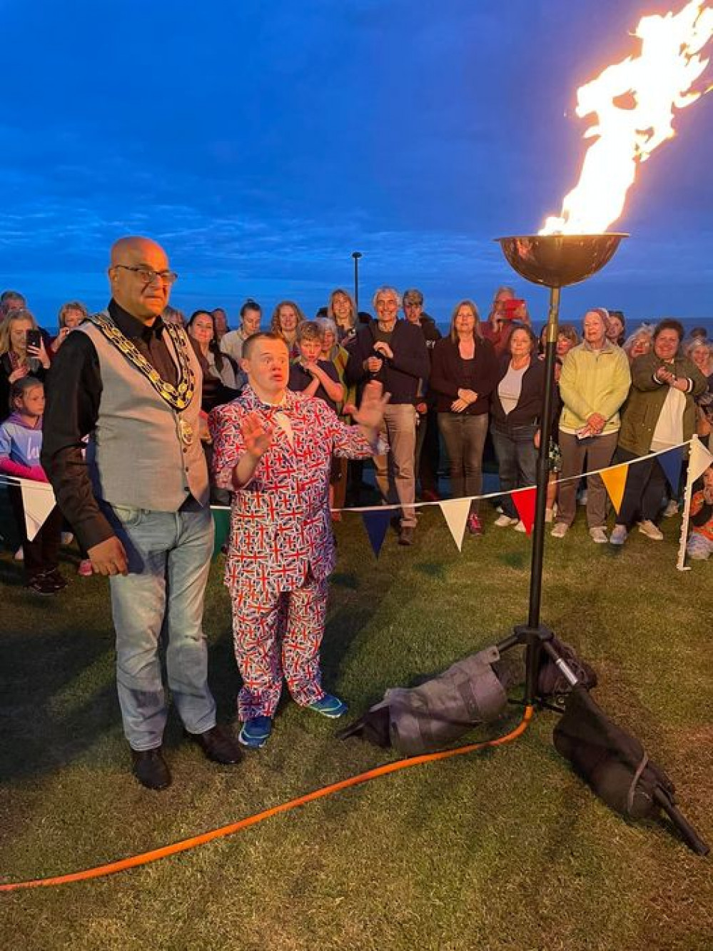 The Mayor of Seaton, Cllr Amrik Singh, and Seaton resident Alfie, light the jubilee beacon (photo credit: Seaton Town Council)