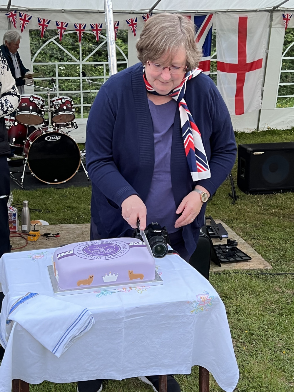 Sue Reynolds cuts the Jubilee cake at All Saints