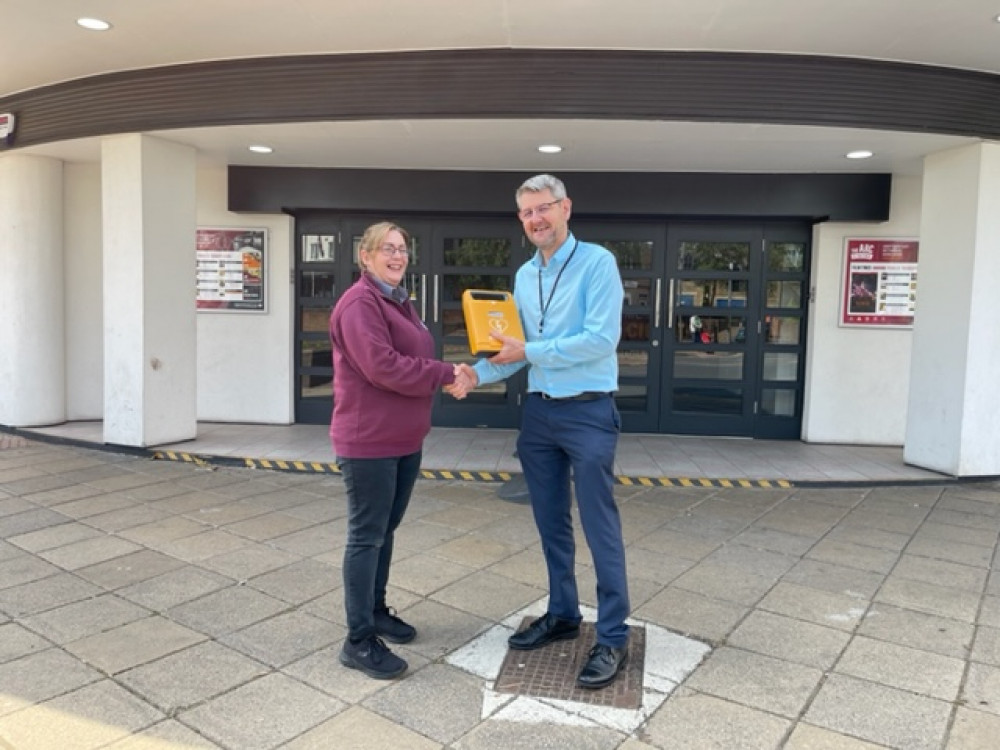 Kelly Golding (left) who led The Arc's efforts to secure a defibrillator is presented it by Trevor Middleton, Town Centres and Markets Manager. Photo courtesy of Arc Cinema, Hucknall.