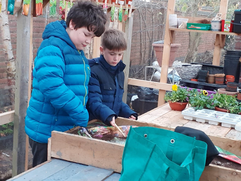 Pupils at St John's Primary in Sandbach Heath in their outside greenhouse classroom