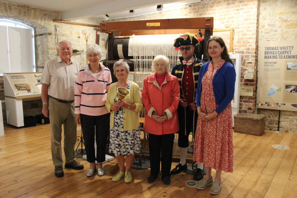 Volunteers from Axminster Heritage Centre and town crier Nick Goodwin as they open doors for the Cherry Fayre