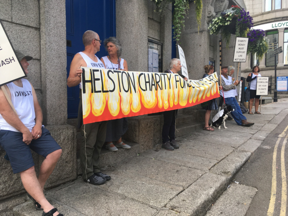 Climate change campaigners at Helston Guildhall - they disrupted the town council meeting taking place inside and police were called (Image: Richard Whitehouse/LDRS).