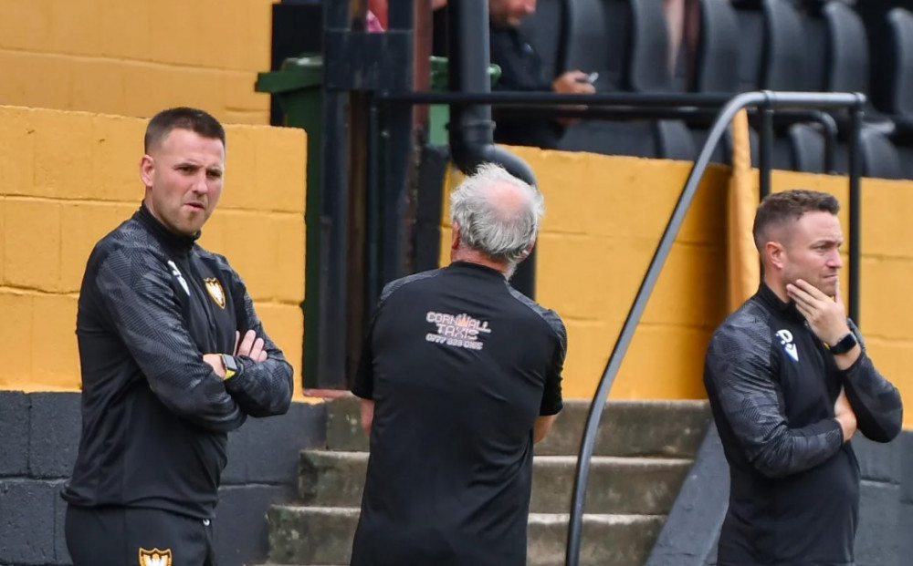 Falmouth Town boss Andrew Westgarth watches on.