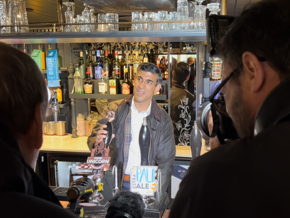 Sunak poses for a photo at the Sweetenham Arms last night  