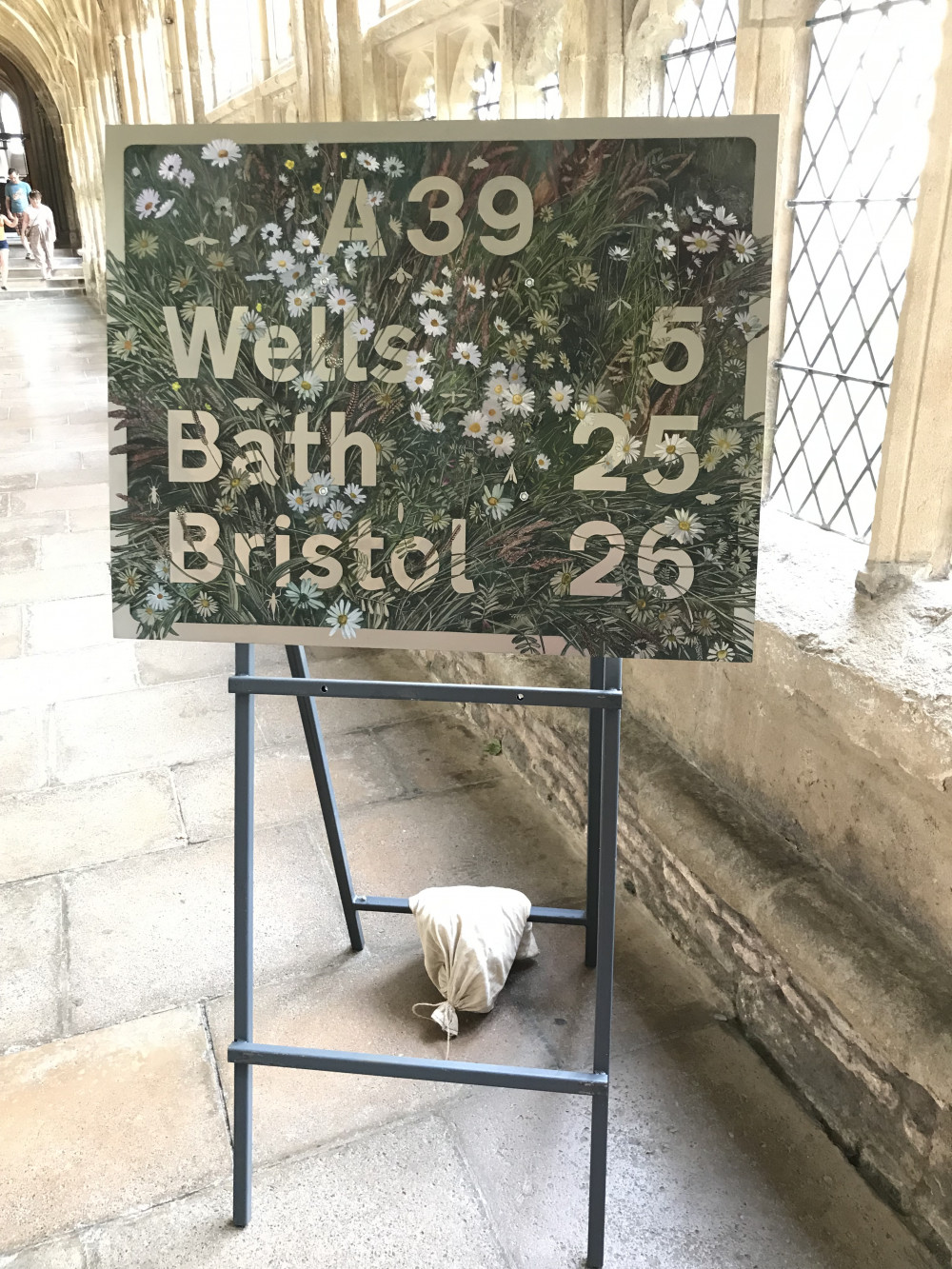 Wells Five Miles by Nessie Ramm. Signs from locations around Wells have been recreated in the Cathedral, adorned with local flowers and plants