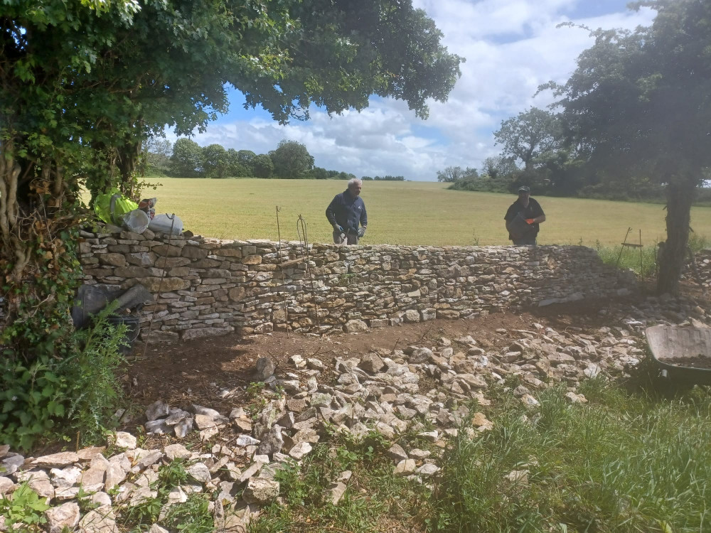 Our loyal wallers completing a stretch of the dry stone wall