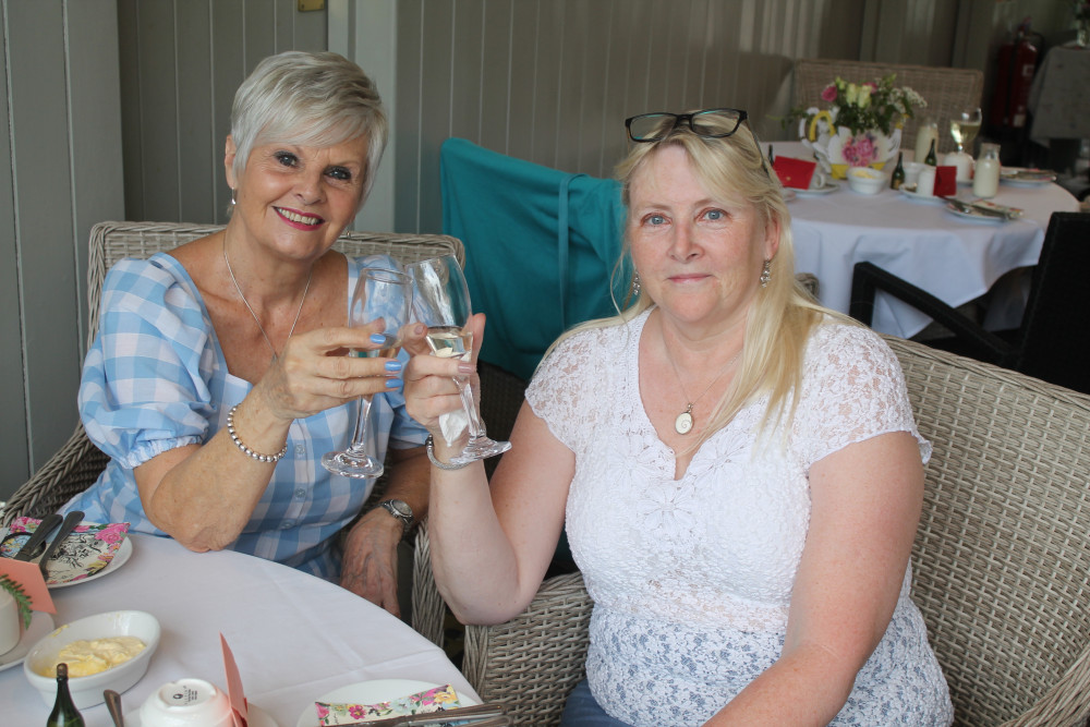 Lorna (left) and Karen raise a glass to the success of Axminster Ladies Group’s first anniversary