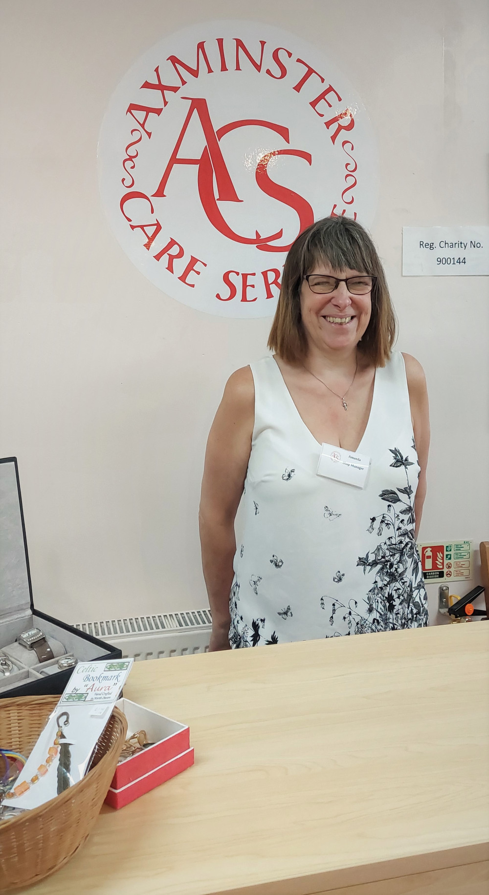 New Axminster Care Service shop manager Amanda Walker behind the till