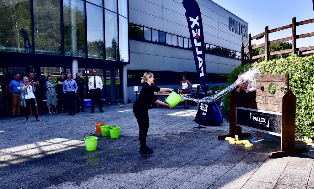 Sian Jones gives Pall-Ex Group CEO, Kevin Buchanan, a soaking at the company's BBQ Extravaganza event