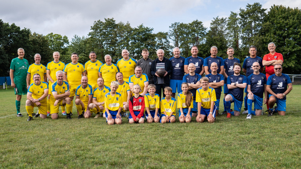 The two teams which took part in an extraordinary replay - PE teacher Alan Jones, who gave the controversial goal, is at the centre of the picture by Tom Maddick, SWNS