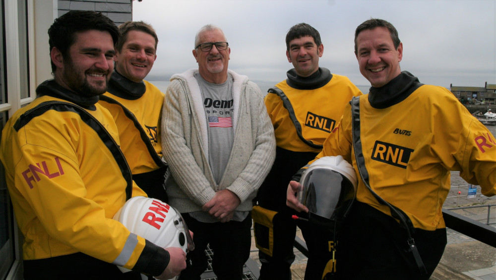 Lyme Regis lifeboat crew members Tom Crabbe, Rich Tilley, Tim Edwards and Andy Butterfield with one of the men they rescued in Axmouth, Brian Harding, 72, from Chard (photo credit: RNLI Lyme Regis)