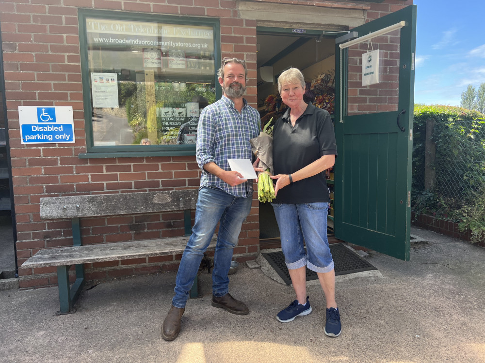 Shop committee member Nick Chandler presenting Jane with a bouquet as a thank you for her hard work and commitment particularly in the period between managers. Picture: Nathalie Robert.