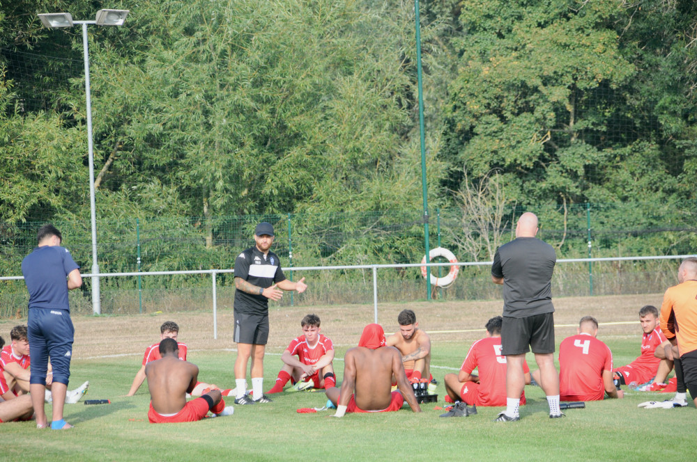 Players heads bowed as Pip Boyland delivers post match message (Picture credit: Nub News)