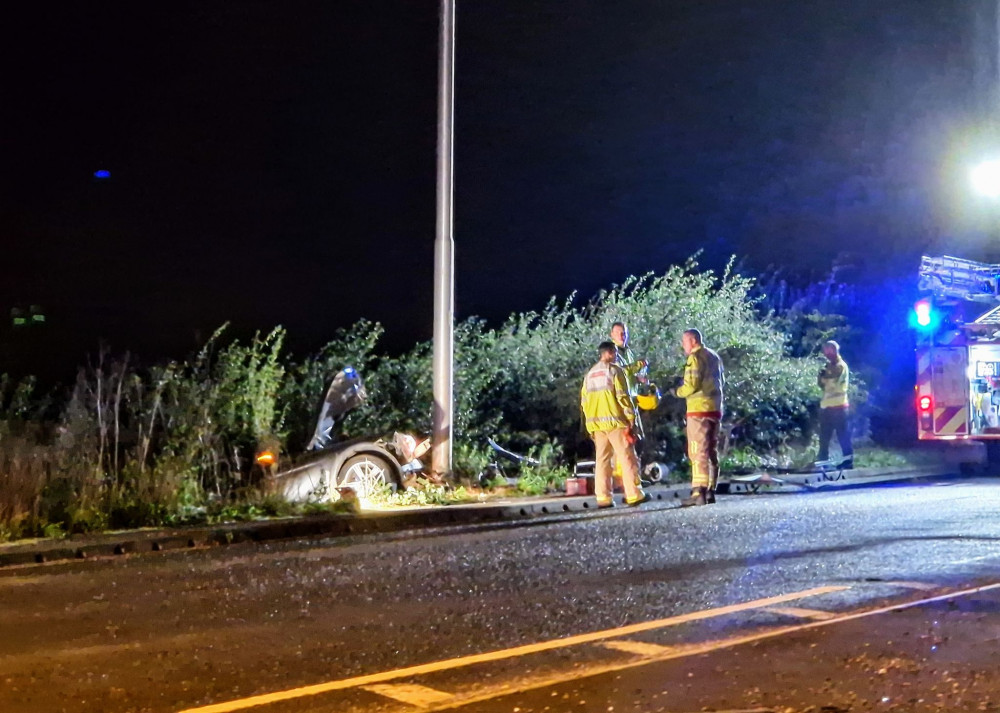 Crewe firefighters dealt with the car that had collided with a lamp post and rested on a live cable (Ryan Parker).